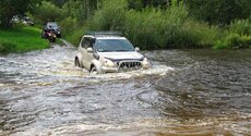 Crossing of the river by off road jeep